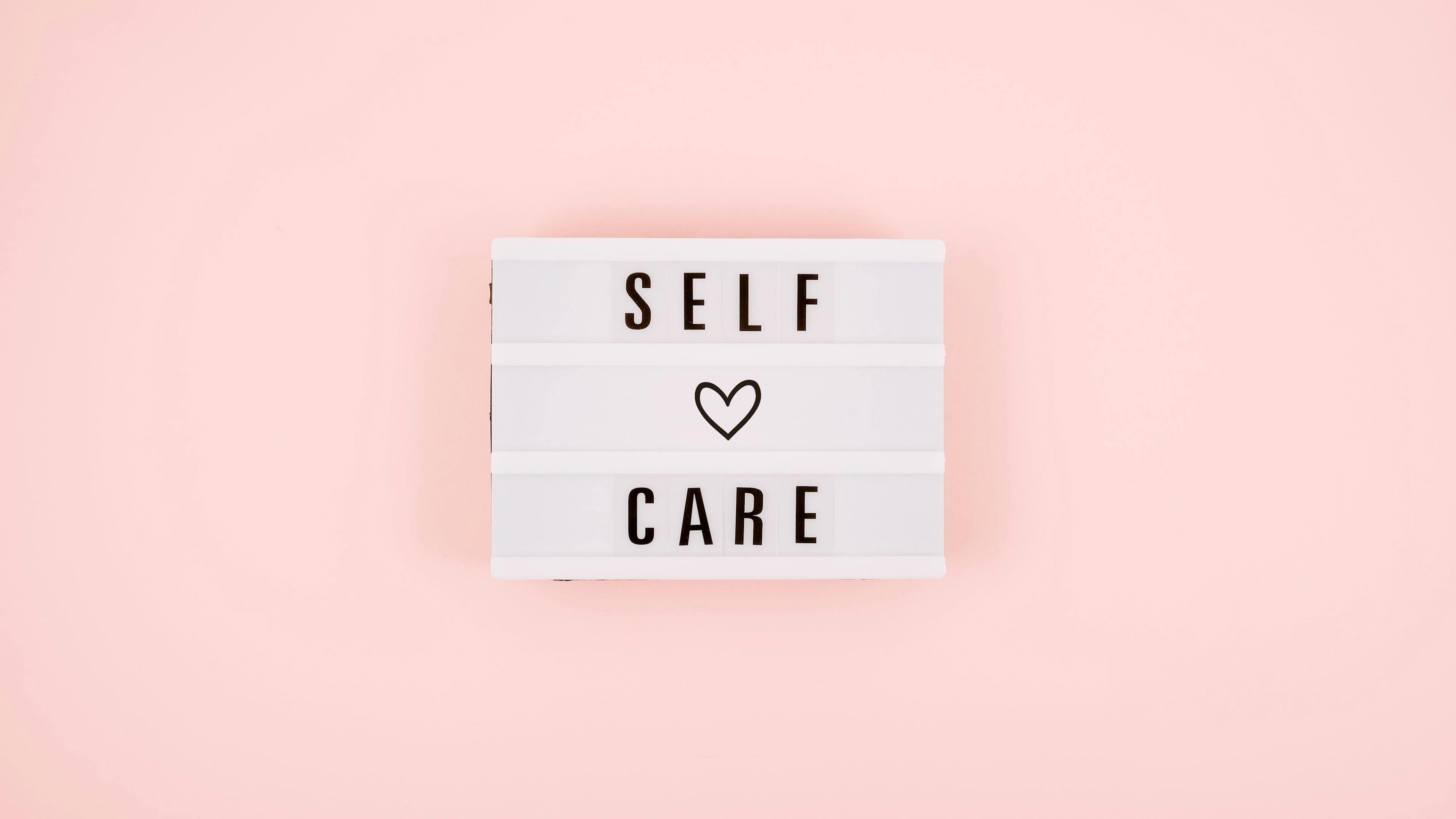 self care sign pink background