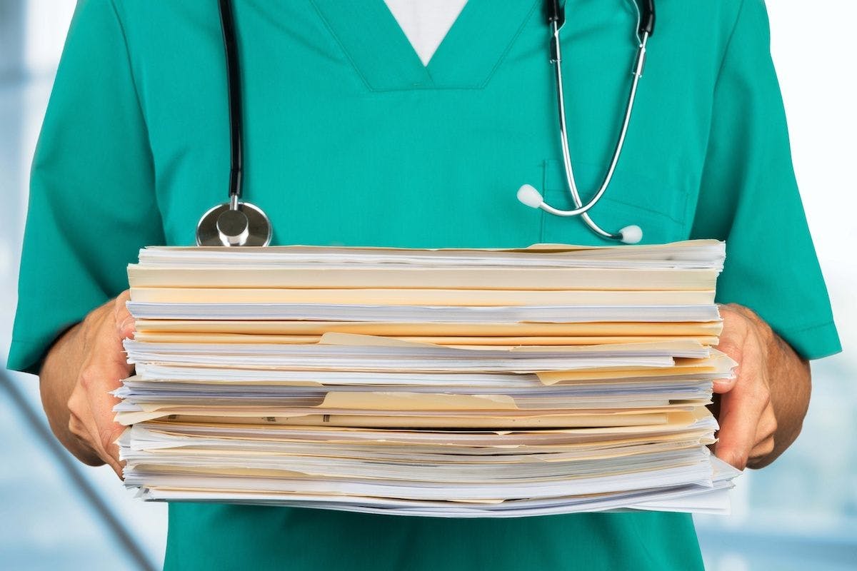 physician holding files paperwork:  © BillionPhotos.com - stock.adobe.com