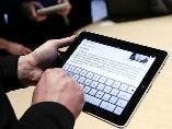 Apple Surges on Chinese Settlement, iPad Mini Rumors