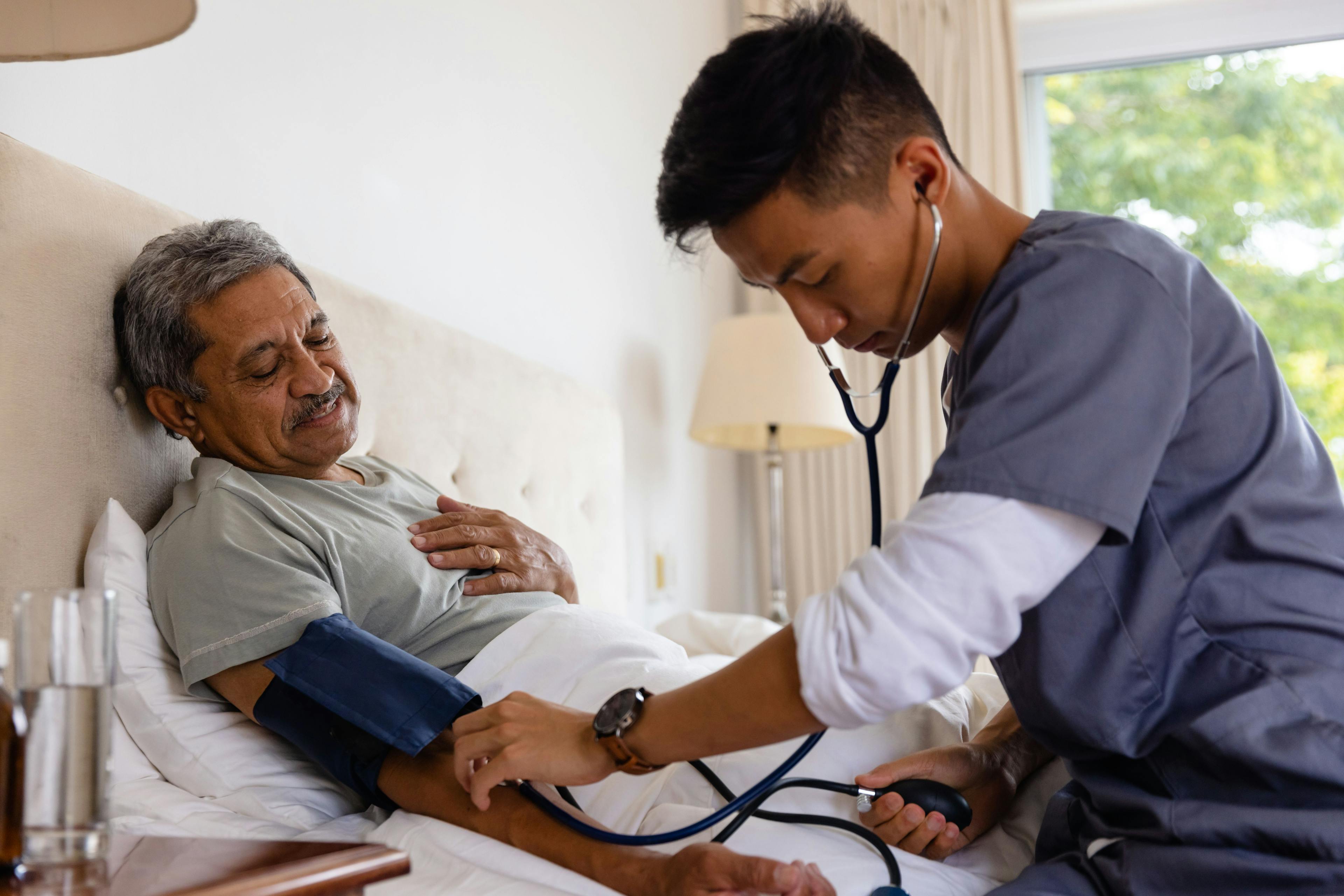 ©wavebreak3 Home care provider taking patient's blood pressure