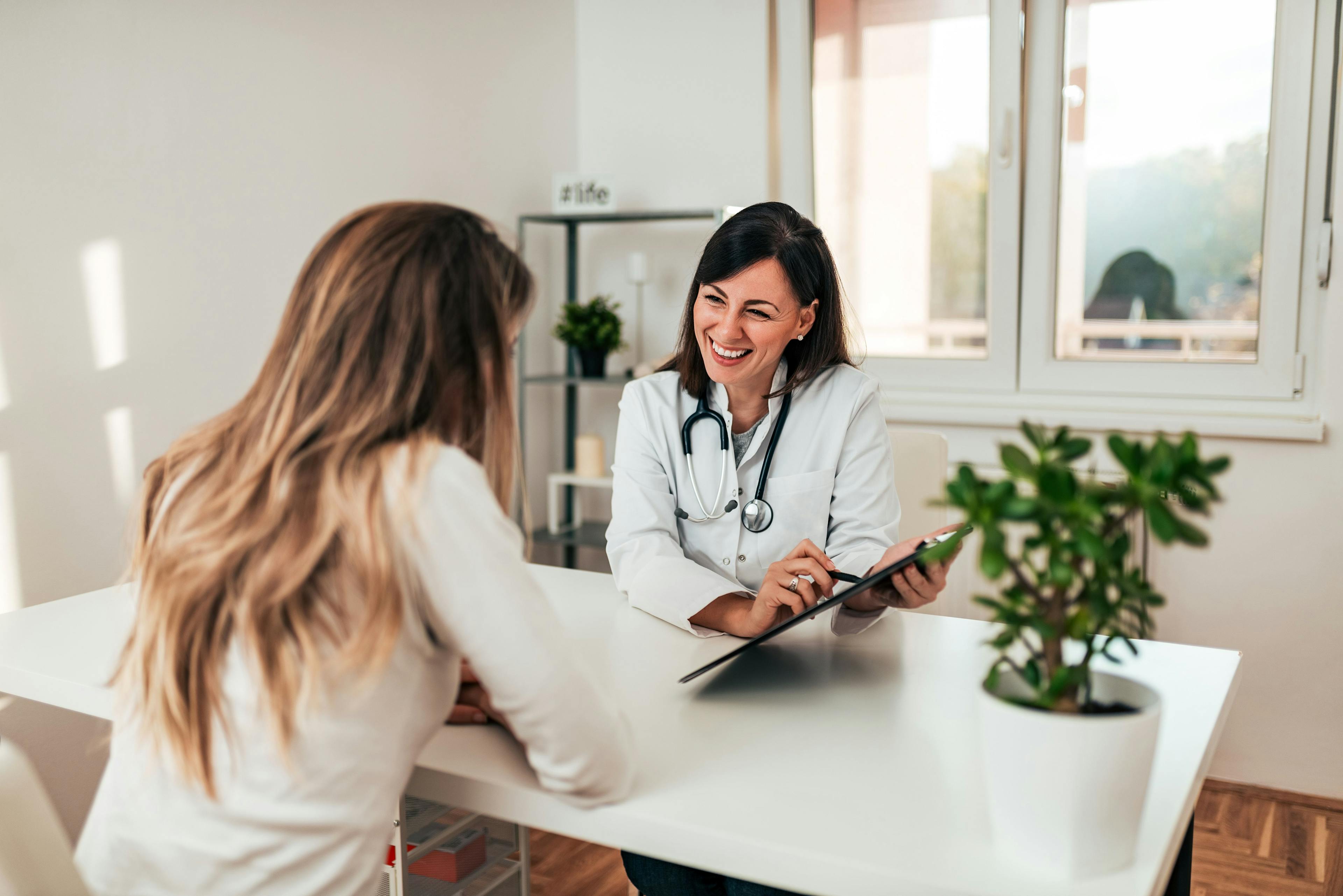 woman physician talking to another woman