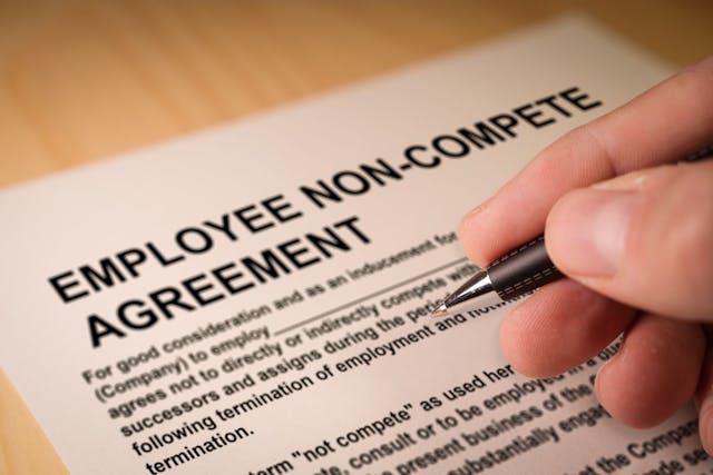 worker signing employee noncompete agreement: © tanaonte - stock.adobe.com