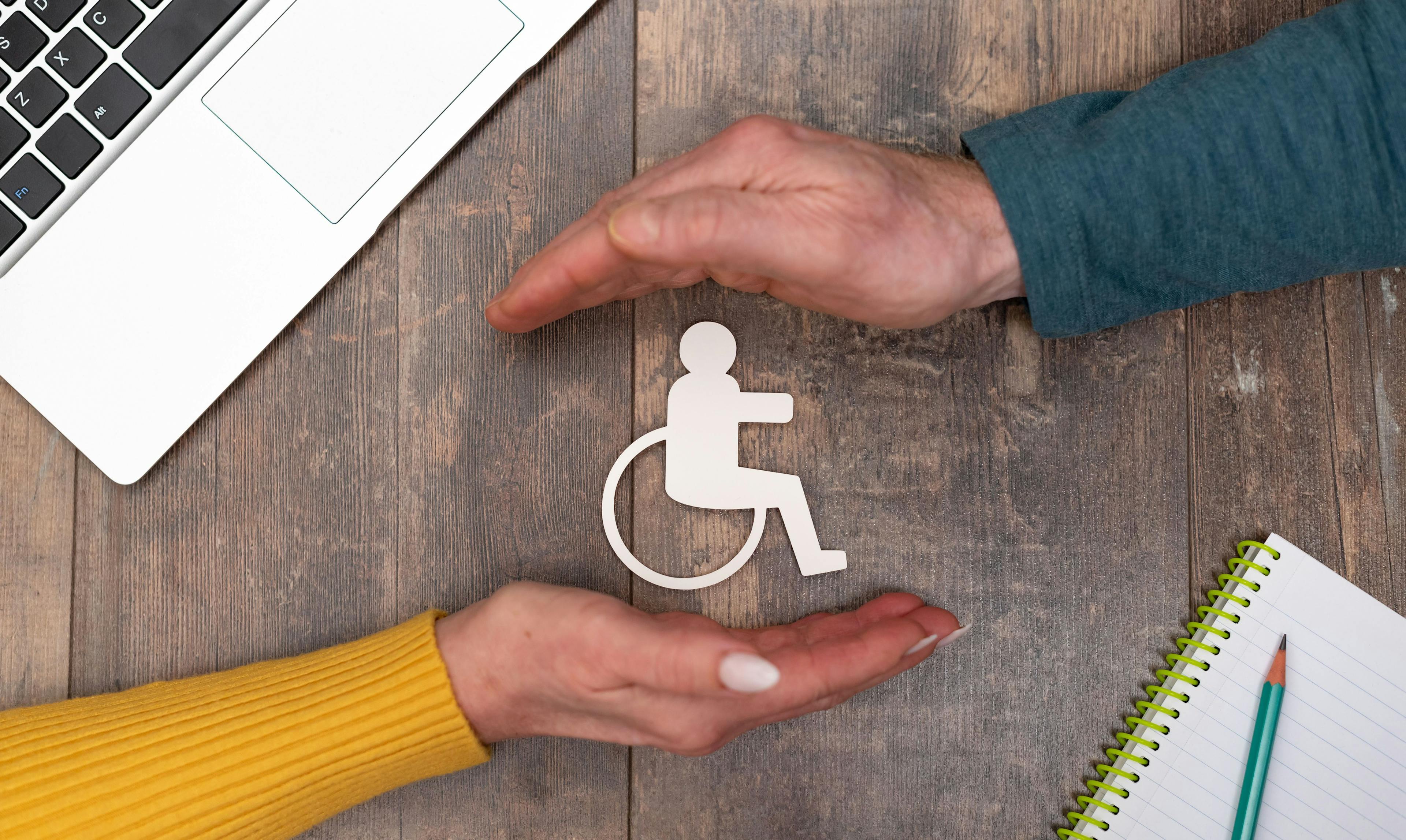 hands around wheelchair disability insurance concept