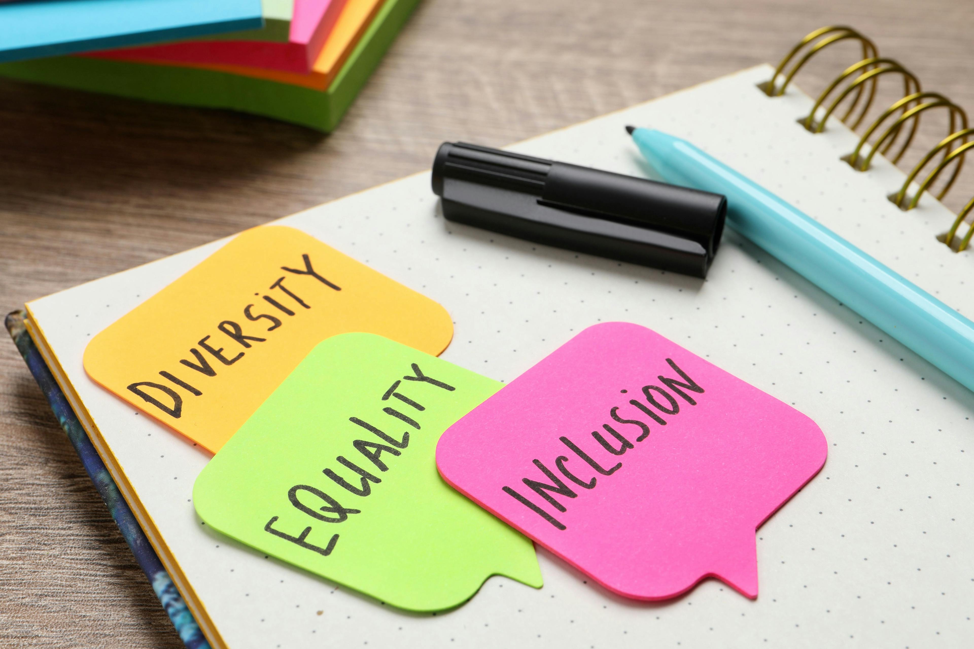 sticky notes with diversity, equality, and inclusion 