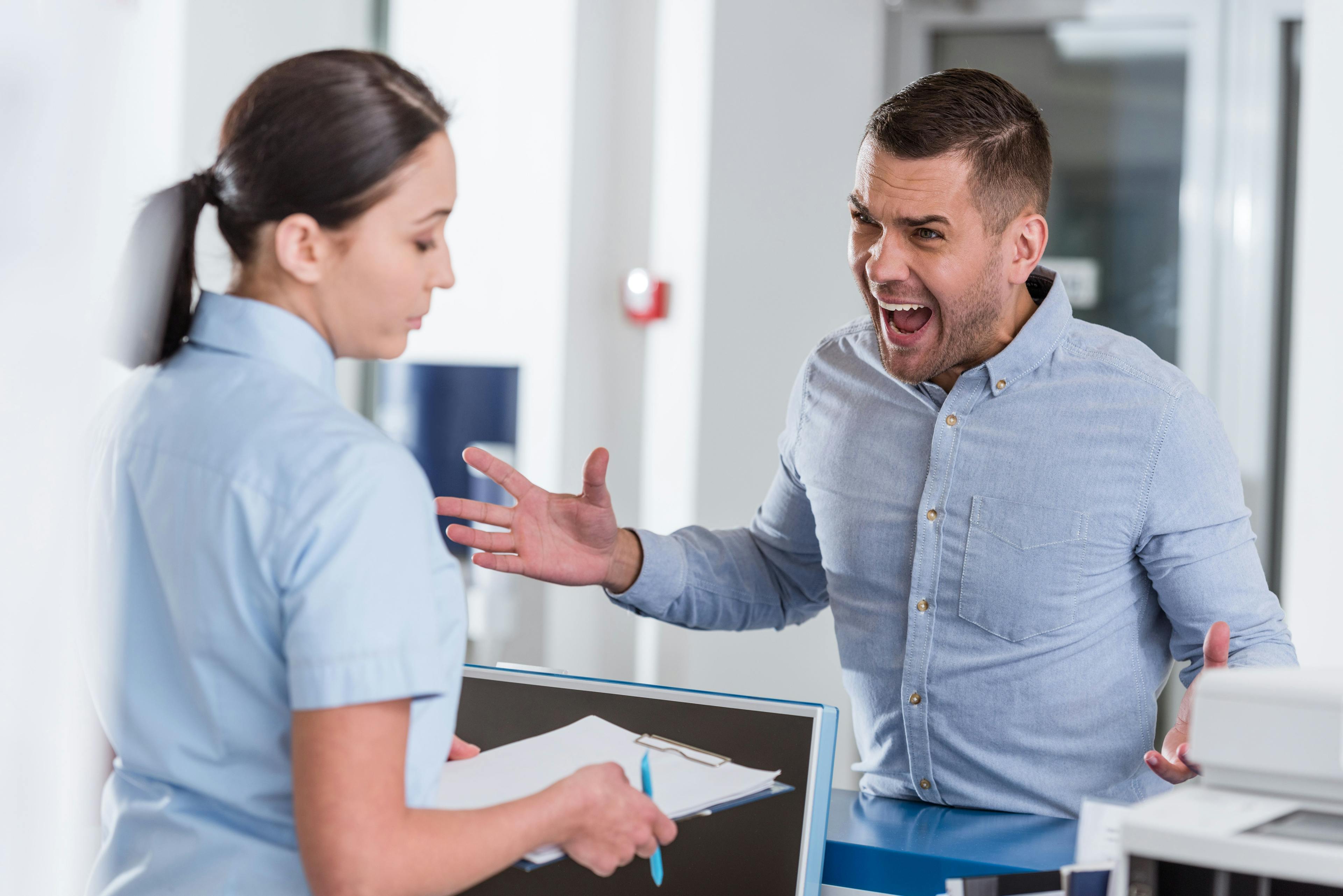 Angry patient confronting practice staff member 