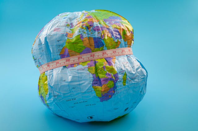 Obese world measuring tape around world