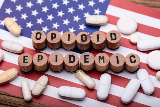 opioid epidemic pills over flag © Andrey Popov stock.adobe.com