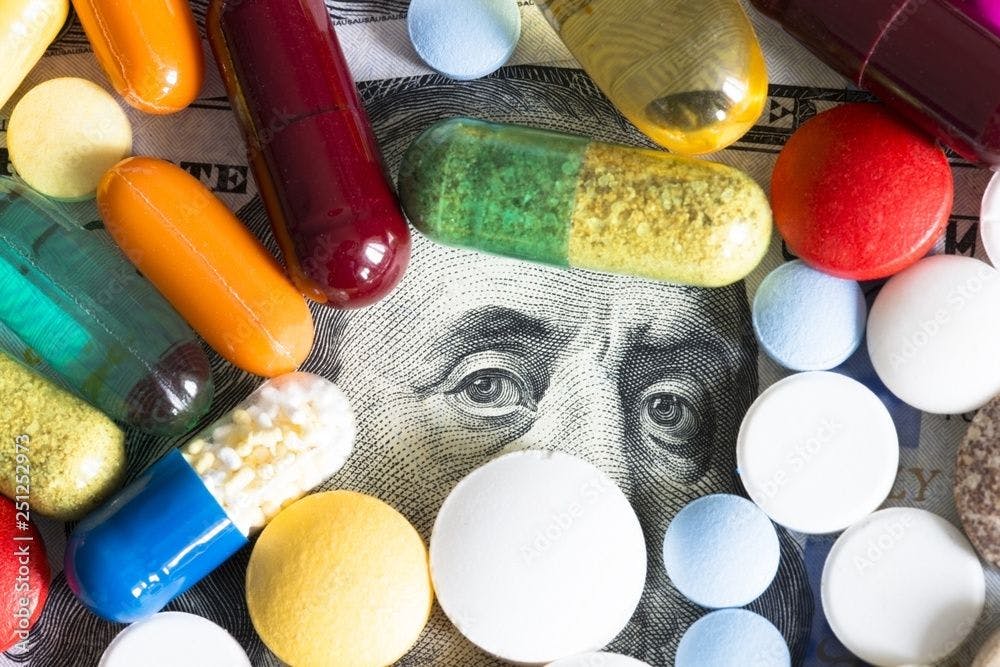 drug capsules and pills on image of Ben Franklin ©adrian_ilie825-stock.adobe.com